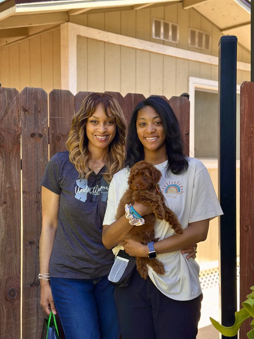 A family with their Adorable Labradoodle