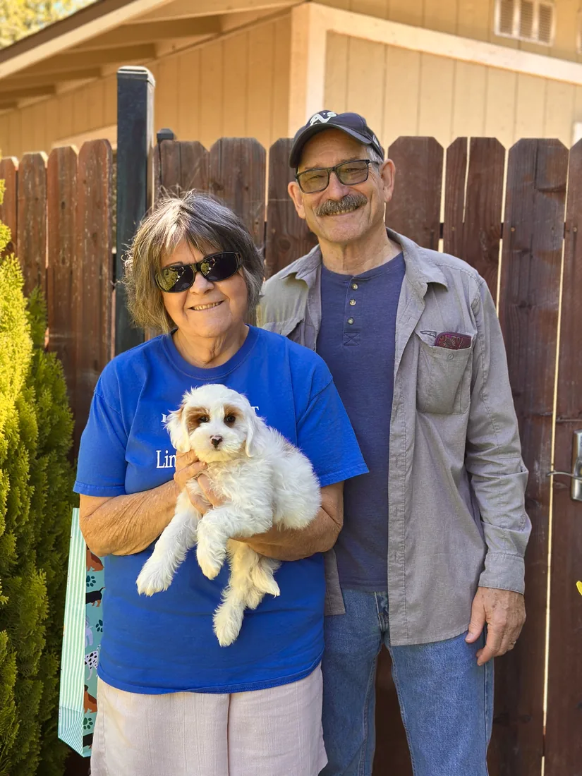 A family with their Adorable Labradoodle