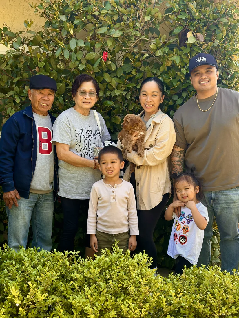 A family with their Adorable Labradoodle