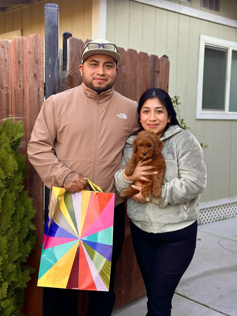A family with their Adorable Labradoodle