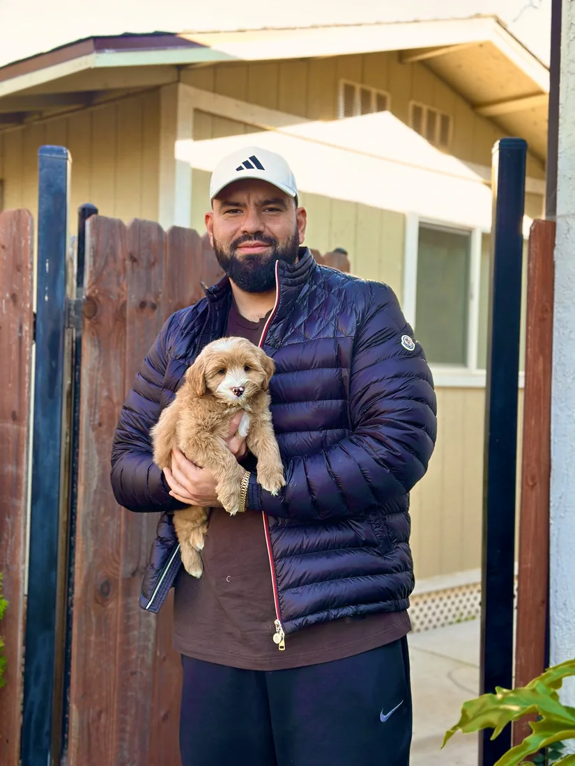 A family with their Adorable Labradoodle
