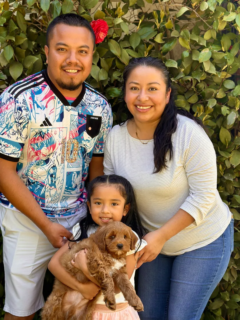 A family with their Adorable Labradoodle