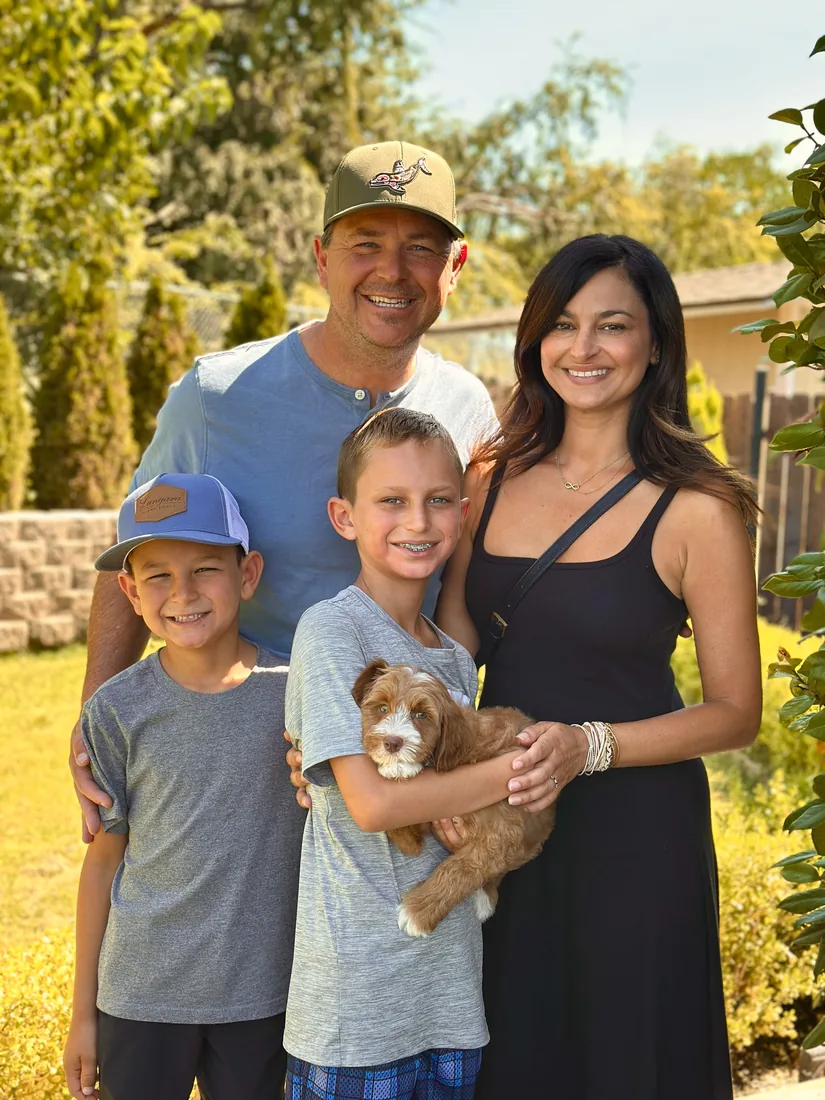 A family with their Adorable Labradoodle