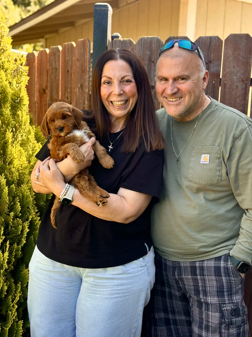 A family with their Adorable Labradoodle