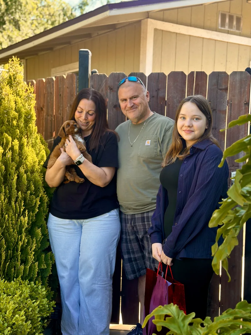 A family with their Adorable Labradoodle