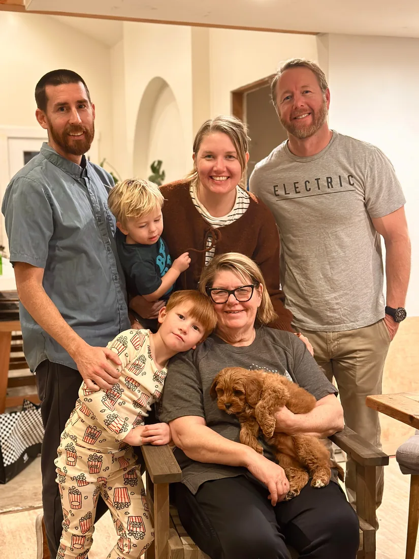 A family with their Adorable Labradoodle