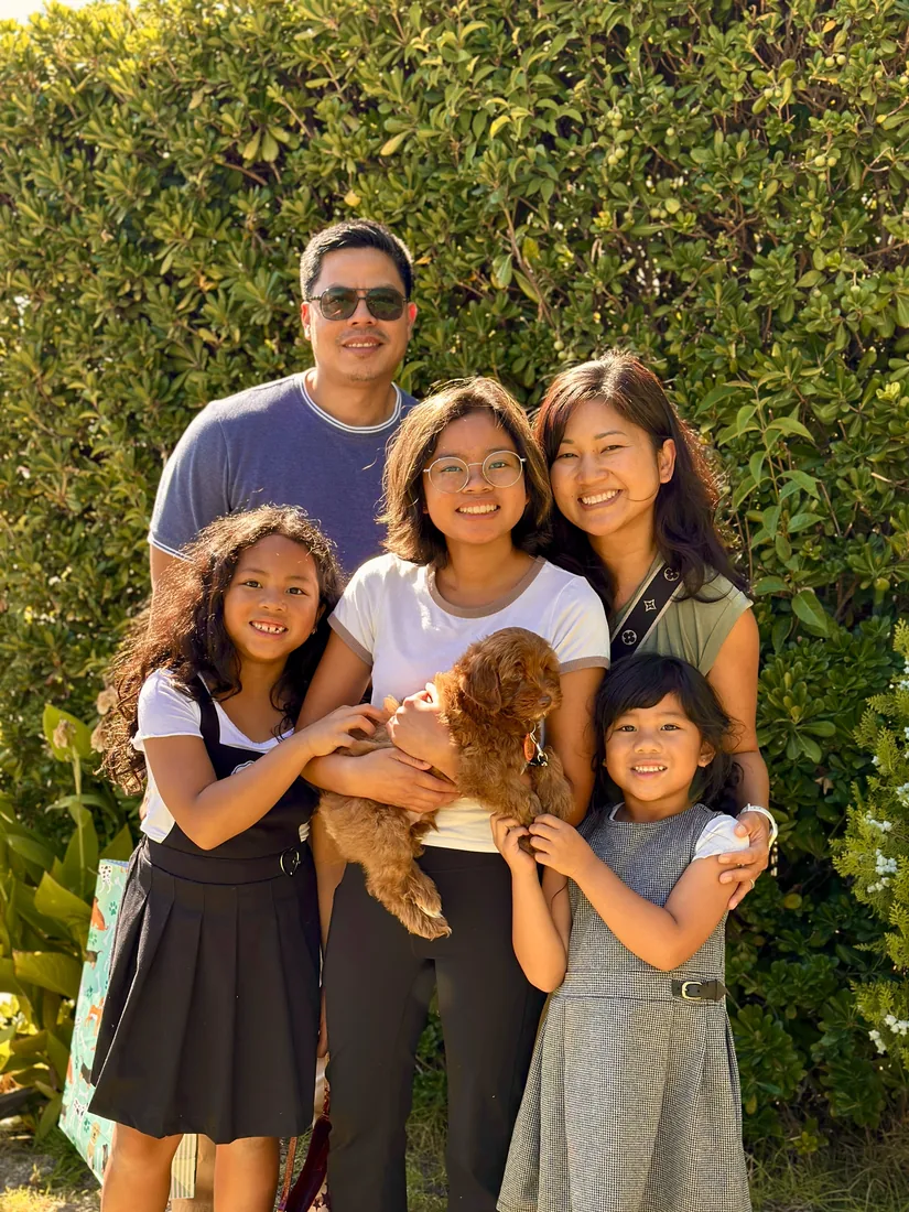 A family with their Adorable Labradoodle