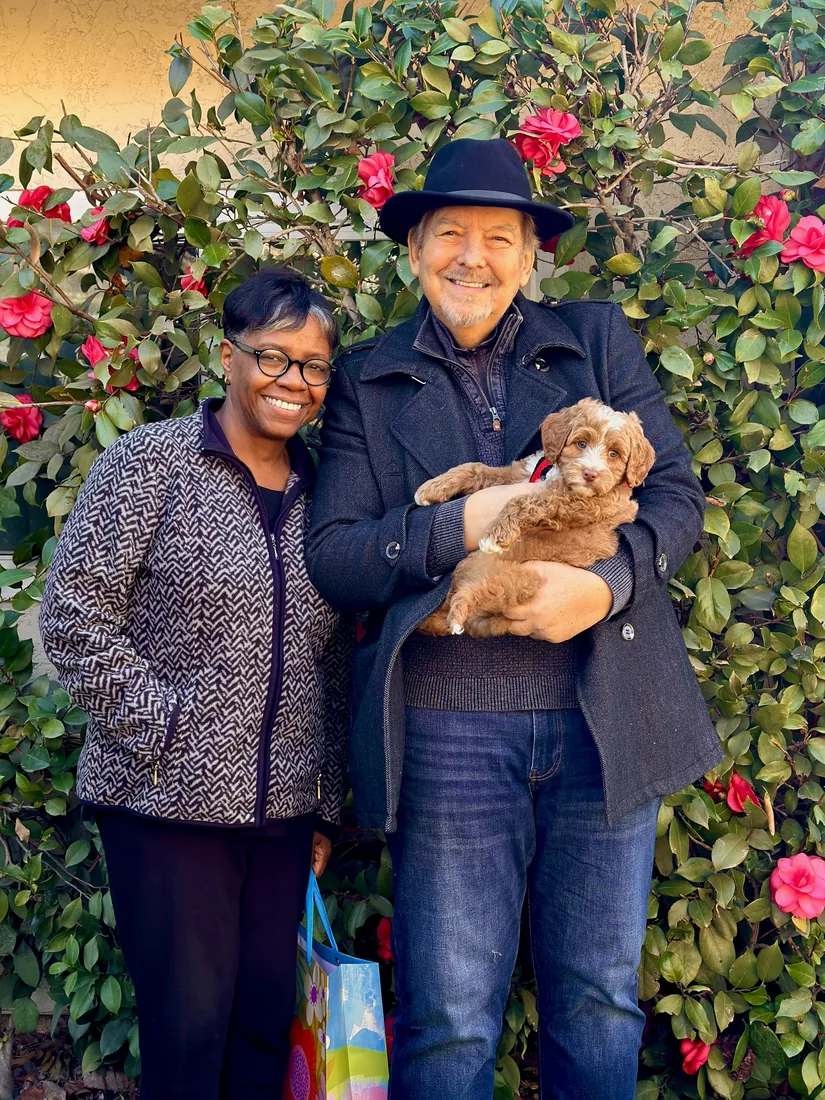 A family with their Adorable Labradoodle