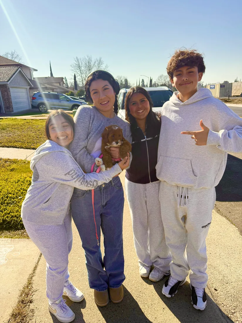 A family with their Adorable Labradoodle